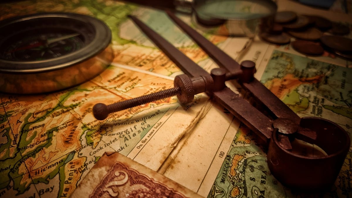 Old compass and tools on a map—showing how ethics needs to guide fintech, not just follow rules.
