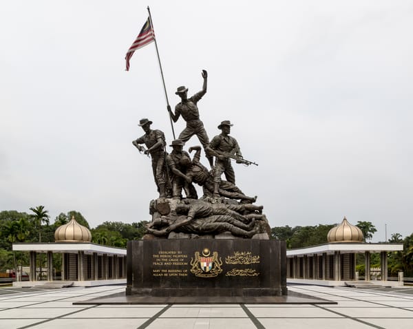 Tugu Negara, Kuala Lumpur — built to honor those who fought for independence. Real Merdeka today is about defending principles that protect people every day.