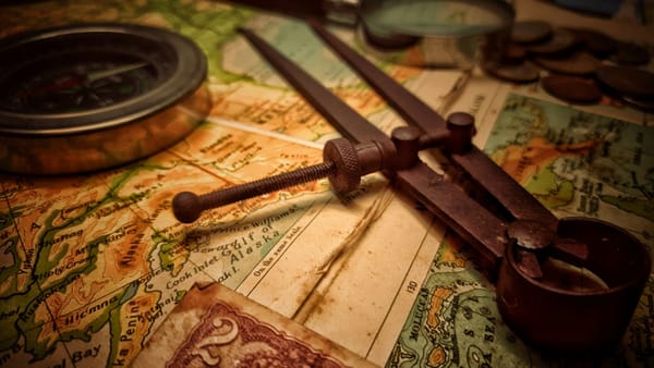Old compass and tools on a map—showing how ethics needs to guide fintech, not just follow rules.