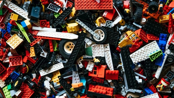 Loose LEGO pieces—showing how ideas don’t work when they aren’t built into real systems.