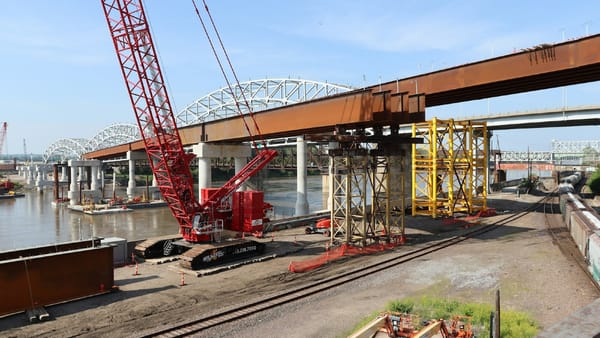 Half-built bridge with machines—showing that trust needs strong structure from the start.